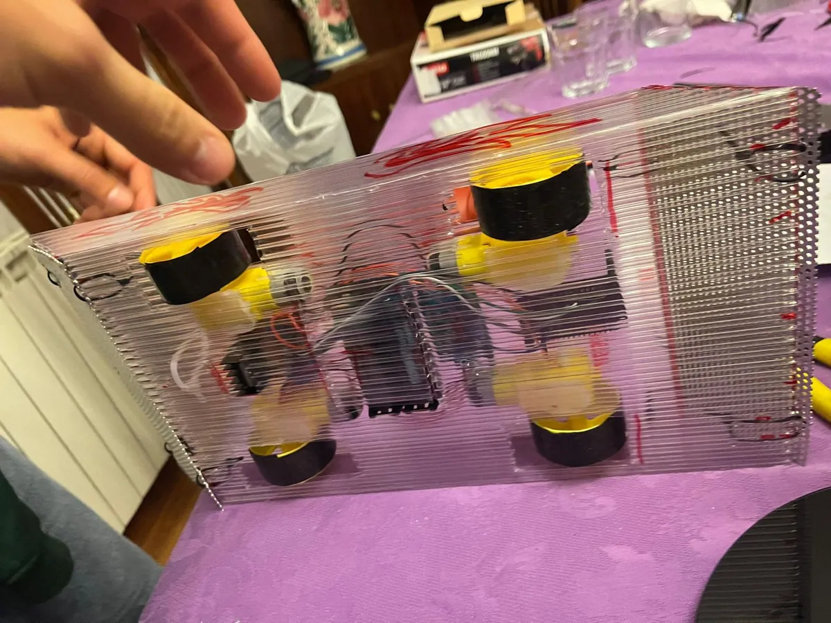 The finished Minotauro robot: a clear polycarbonate shell over four yellow wheels.