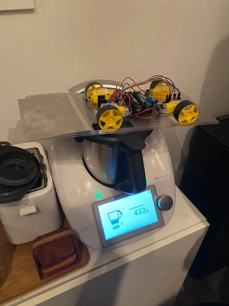 The robot on a kitchen scale reading 453 grams.